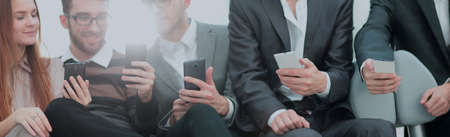 Group of young people use their phonesの写真素材