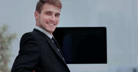 Image of businessman working in office in front  his laptop co