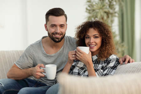 Close-up of a loving couple sitting on a sofa in the living room