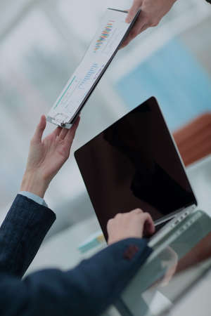 Businessman giving document to his colleague at meetingの写真素材
