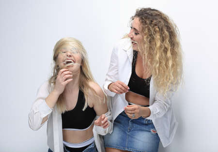 two young female models standing next to each otherの写真素材