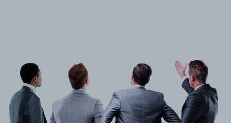 four business mans from the back - looking at something over a white background