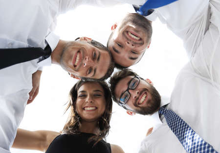 successful business people with arms around each others shoulders.の写真素材