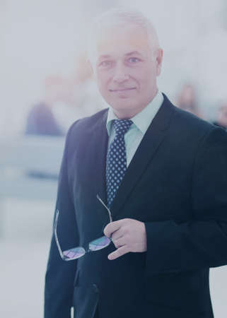 Portrait of mature businessman with  colleagues interacting on bの写真素材
