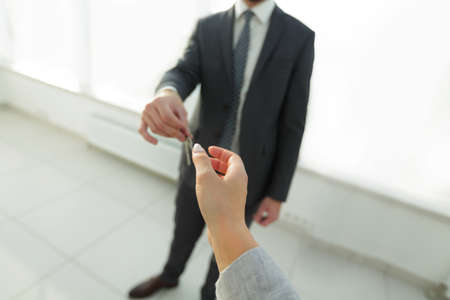 Estate Agent Giving House Keys To Person