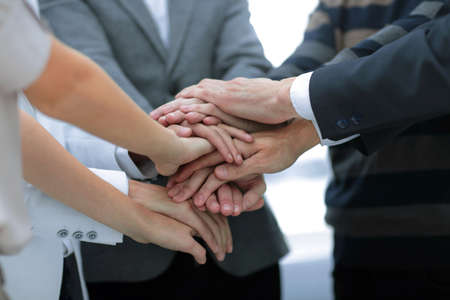 Closeup of a business colleagues with their hands stacked togetherの写真素材