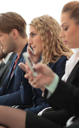 closeup of colleagues sitting at a business conference.の写真素材