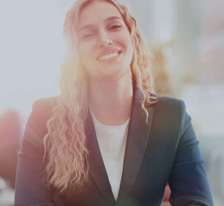 Successful business woman with her staff in background at office
