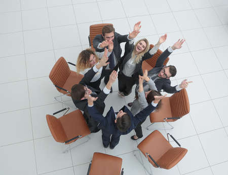 view from the top. business team with their hands up.の写真素材