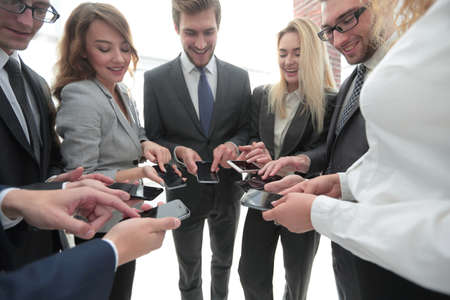 close-up of smartphones in the hands of business youthの写真素材