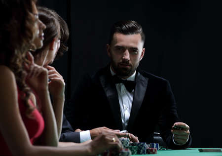 Upper class friends gambling in a casinoの写真素材