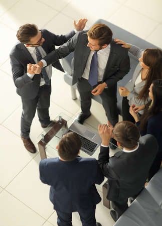 Happy successful business team giving a high fives gesture as thの写真素材