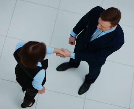 Top view of a businessman and businesswoman shaking hands - Welcome to business.の写真素材