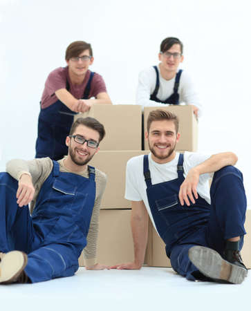 Satisfied and proud movers leaning on stack of boxes isolated onの写真素材