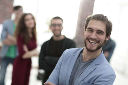 successful designer in the background of his team