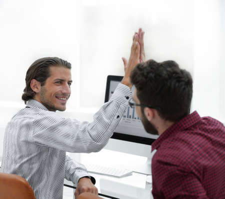members of the business team giving each other a high five