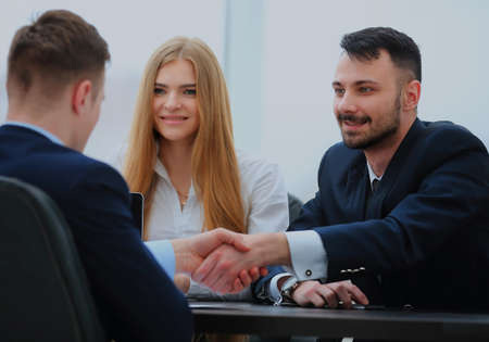 Confident business people shaking hands.