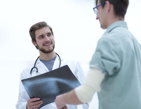 orthopedic surgeon examining an x-ray of the patientの写真素材