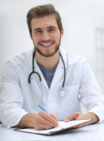background image of a doctor writing out a prescriptionの写真素材