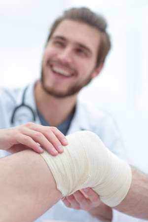 closeup of a doctor examining injured leg of the patientの写真素材