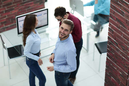 Creative business people listening to young man explanations.