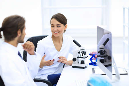 Side view of two scientists conducting a chemical experiment