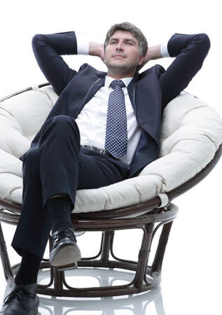 Portrait of a successful businessman sitting in a soft comfortable chairの写真素材