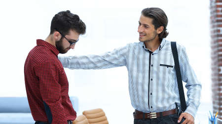 two employees are talking in the officeの写真素材