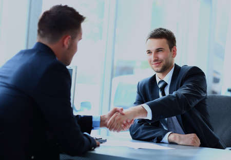 businessman shaking hands to seal a deal with his partner.の写真素材