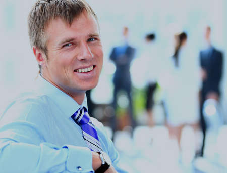 Portrait of smiling young businessman at office.