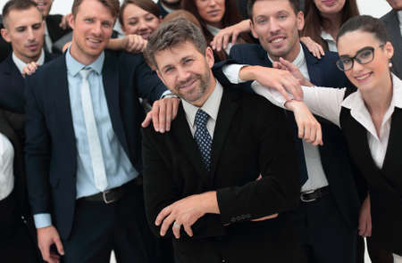 confident businessman standing on background of her business team.