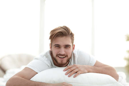 closeup.smiling man lying on the sofaの写真素材