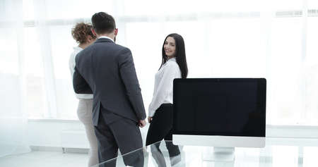 company employees standing in a modern office.
