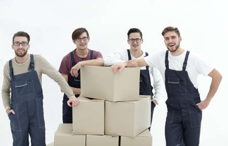 Men holding pile of carton boxes isolated on white backgroundの写真素材