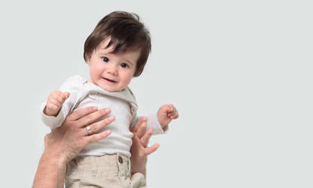 Father throws his laughing son in the airの写真素材