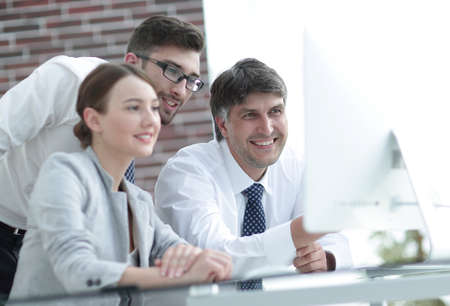 Business team discussing information sitting at the desk