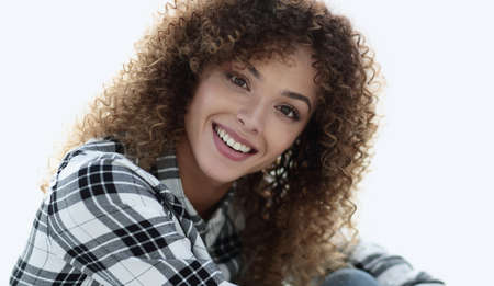 young woman with curly hair in a plaid shirt