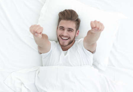 top view.happy man lying on the couchの写真素材