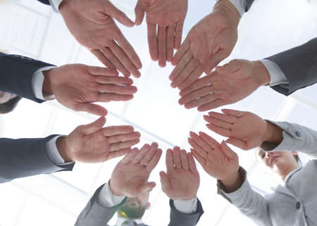 business team with folded their hands in a circleの写真素材