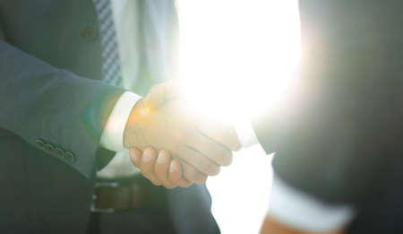 Businessman giving his hand for handshake to partner