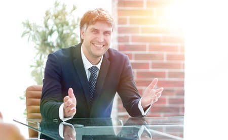 Successful businessman sitting in an empty desk
