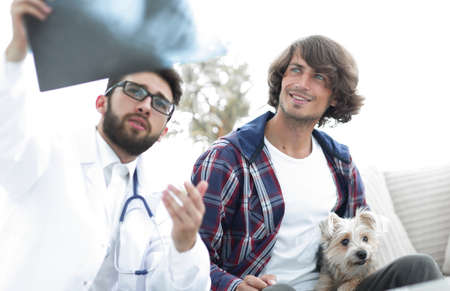 veterinarian showing an x-ray to the owner of the dog.