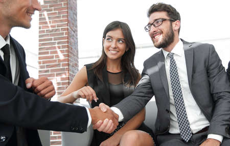handshake Manager and the client at a meeting in the office lobby.