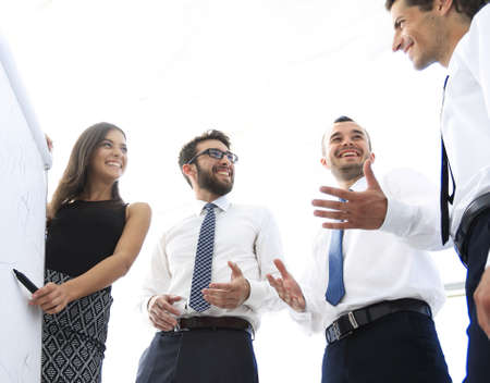 young business woman is colleagues their ideas on the flipchart.