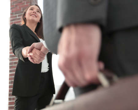 Close up of businessman and businesswoman shaking hands