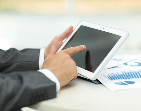 closeup.of businessman hand working with tablet computer