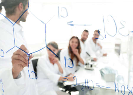 view through the transparent Board. a scientist makes a report.の写真素材