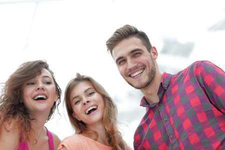 closeup of three young people smiling on white backgroundの写真素材