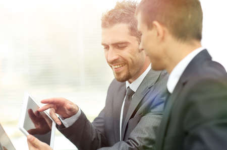 business colleagues working with tablet computer.の写真素材