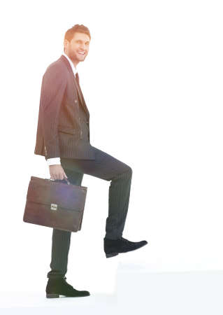 in full growth. a businessman with a leather briefcase walks up.の写真素材